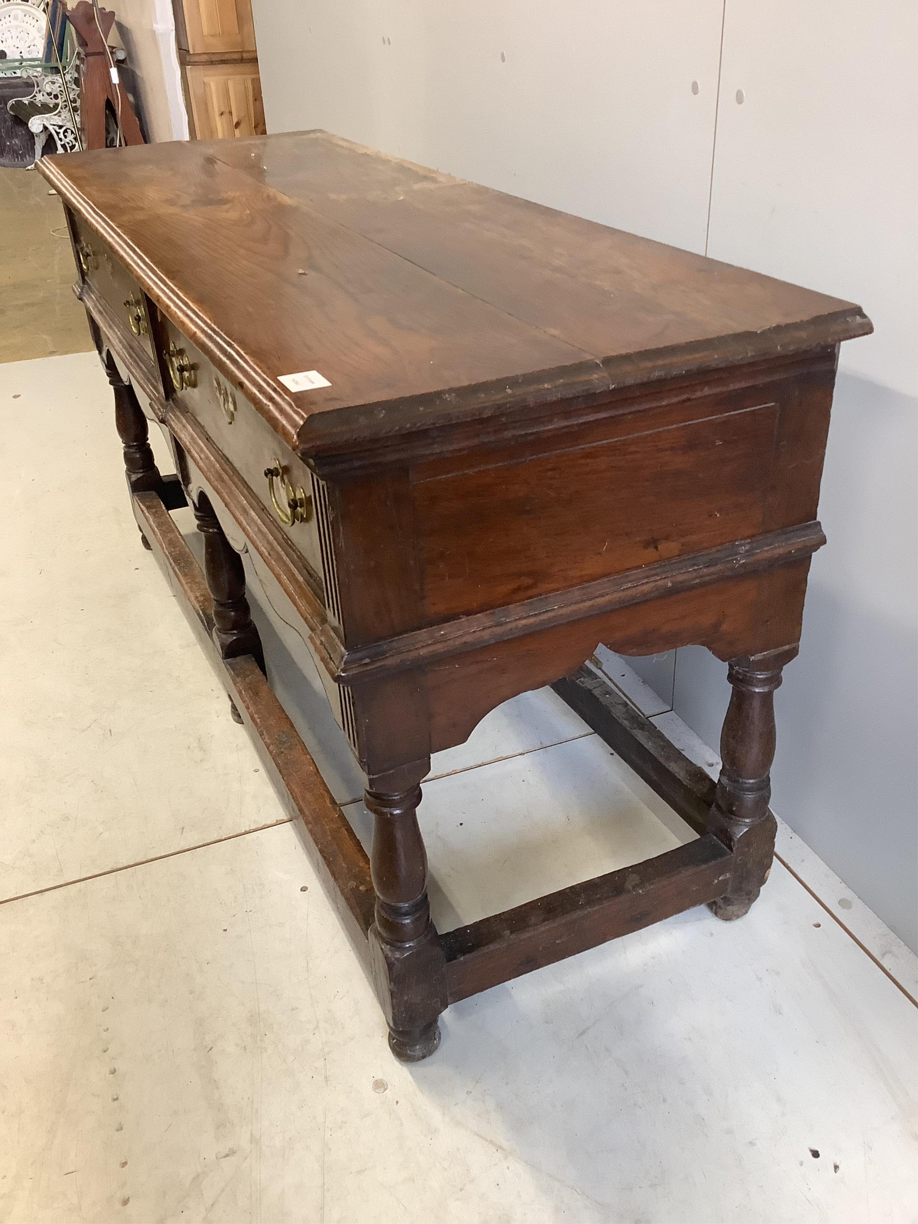 An 18th century oak low dresser base with two long drawers, width 150cm, depth 53cm, height 77cm. Condition - fair